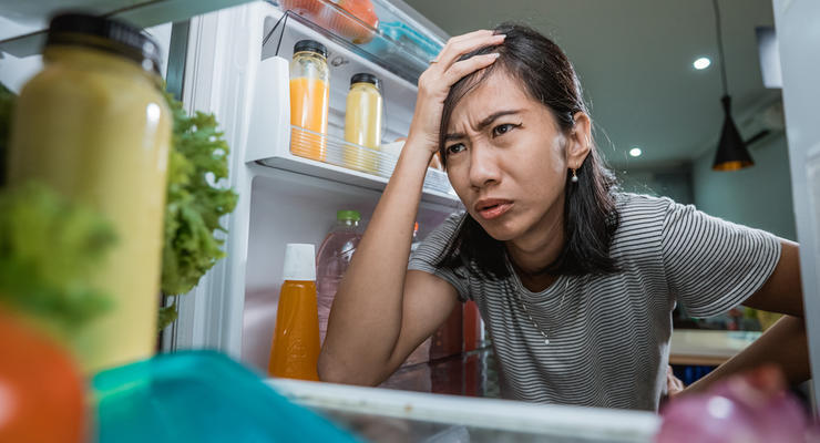 Unhappy Young Asian Woman Looking Inside The Fridge